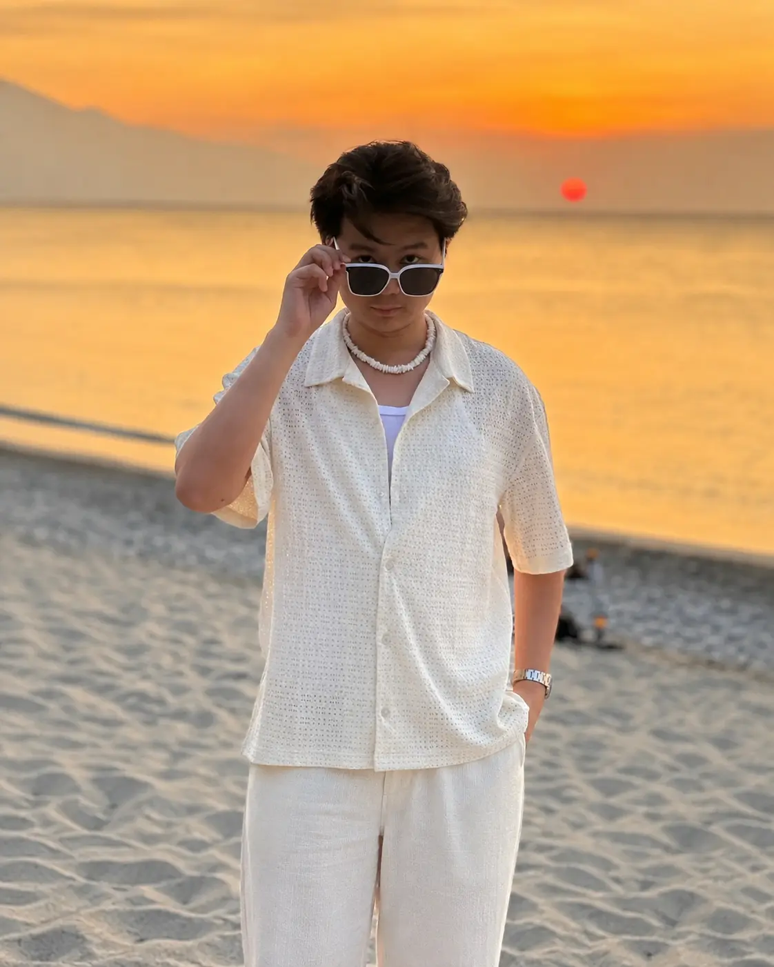 Sean John Camara on a beach at sunset
